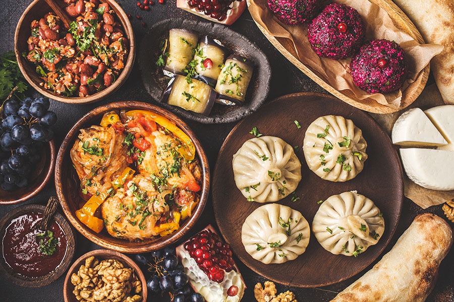 Traditional Georgian Cuisine Background. Khinkali, Phali, Chahok